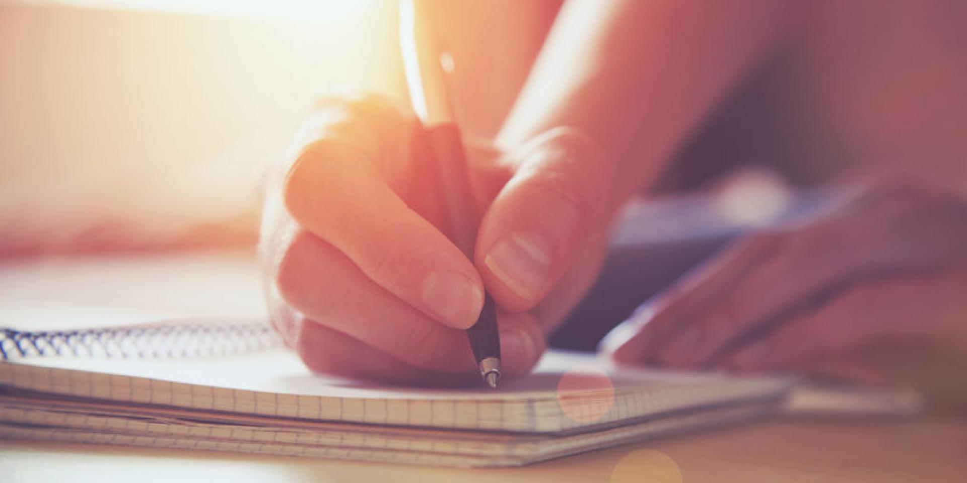 46651061 - female hands with pen writing on notebook