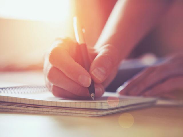 46651061 - female hands with pen writing on notebook